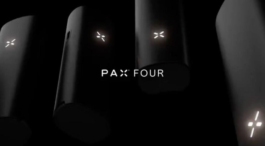 **Alt text:**
Close-up promotional image of several sleek black PAX Four vaporizer devices displayed against a dark background. The illuminated PAX logos glow softly, with the text “PAX FOUR” centered in the image.